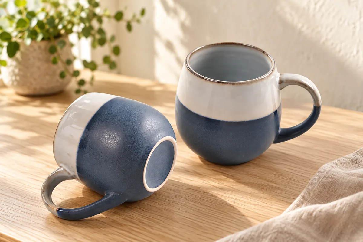 Rounded two-tone mugs — AI styled scene